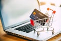 Small shopping cart with credit card on laptop, online shopping and shopping concept Royalty Free Stock Photo