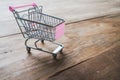 Small shopping cart,Empty shopping trolley on wooden floor Royalty Free Stock Photo