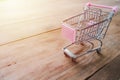 Small shopping cart,Empty shopping trolley on wooden floor Royalty Free Stock Photo