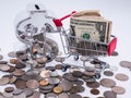 Small shopping cart with a financial symbol banknotes and coins and banknotes  exchange money using as shopping online or Royalty Free Stock Photo