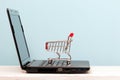 Small shopping cart on Laptop for shopping online Royalty Free Stock Photo