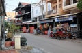 Small shops along the city street. Moped Rickshaw