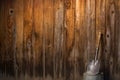 Small shovel leaning against wooden fence Royalty Free Stock Photo