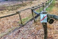 Small sign indicating no cycling on pedestrian path between wooden fence Royalty Free Stock Photo