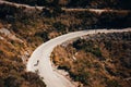 Small silhouette of rider on road bicycle, downhill on Sa Calobra, Mallorca Royalty Free Stock Photo