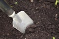 small silver and black gardening shovel mixing dirt soil in various patterns Royalty Free Stock Photo