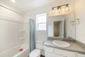 Small and simple bathroom interior with vanity and window Royalty Free Stock Photo