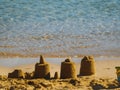 Small simple sand castles on an empty beach