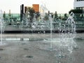 A small singing fountain in the open air, on the street. Drops of water, jets of water frozen in the air in flight Royalty Free Stock Photo