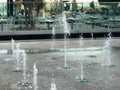 A small singing fountain in the open air, on the street. Drops of water, jets of water frozen in the air in flight Royalty Free Stock Photo