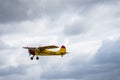 Small single engine airplane flying in the english cloudy sky