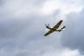 Small single engine airplane flying in the english cloudy sky