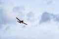 Small single engine airplane flying in the english cloudy sky