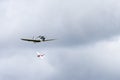 Small single engine airplane flying in the english cloudy sky