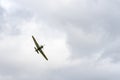 Small single engine airplane flying in the english cloudy sky