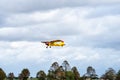 Small single engine airplane flying in the english cloudy sky