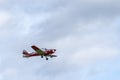 Small single engine airplane flying in the english cloudy sky