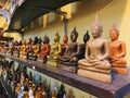 Small sitting Buddha statues on a shelf in a store