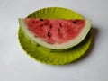 Small Size Cut or Sliced Water Melon Fruit in a Green Plate isolated on white Background Royalty Free Stock Photo