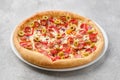 Small size pizza with thin sausage, bell pepper, olives Royalty Free Stock Photo