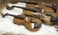 The small size of violin put in front of blurred bigger violins,show detail of acoustic instrument