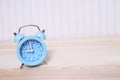 Small sized old vintage retro alarm clock blue with bells Put on a Woman beach Royalty Free Stock Photo