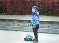 Small smiling boy holding toy truck