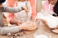 Small smiling boy is whipping eggs in bowl with his sister and grandmother Royalty Free Stock Photo