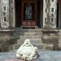 Small, smiling Buddha sitting in front of the Co Le Pagoda in North Vietnam.