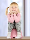 Small smily girl sits on a potty Royalty Free Stock Photo