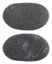 A small smooth black coast stone pebble turned by waves of the