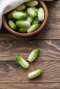 Small snack cocktail Dutch cucumbers Quirk variety on wooden background