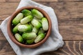 Small snack cocktail Dutch cucumbers Quirk variety on wooden background Royalty Free Stock Photo