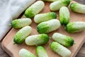 Small snack cocktail Dutch cucumbers Quirk variety on wooden background, selective focus Royalty Free Stock Photo