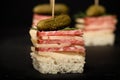 Small snacks canape with salami, cheese and pickle on skewer on Royalty Free Stock Photo