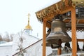 Small snow-covered bell tower with silver bells of the Orthodox Church Christmas holidays. The concept of Orthodoxy