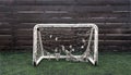 Small soccer goal with old net in the playground for children.