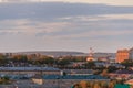 Small soviet city on sunset.The sun comes out from behind the clouds.