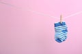 Small socks hanging on washing line, space for text. Baby accessories Royalty Free Stock Photo