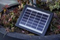 A small solar cell designed to generate low-power electricity outdoors, surrounded by vegetation, eco-friendly Royalty Free Stock Photo