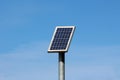 Small solar panel mounted high on top of metal pole