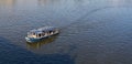 Small solar-powered excursion boat on the Vltava River in Prague Royalty Free Stock Photo