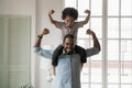 African Ethnicity Little Son Sitting On Fathers Shoulders Showing Biceps