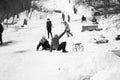 Small southern romanian village. Scenes from a moody winter with children playing with sledges and enjoying the snow