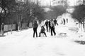 Small southern romanian village. Scenes from a moody winter with children playing with sledges and enjoying the snow