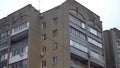 A small Soviet apartment building. Faded building left after the USSR. Concrete building with balconies panoramic view
