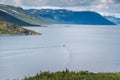 Small speed boat leaves traces on the water in the lake in Jotunheimen national park, traveling to Norway Royalty Free Stock Photo