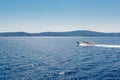 A small speedboat sails along the calm waters Royalty Free Stock Photo