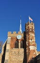 Small spire, clock and flag on St Mary`s Church Tower, Hitchin