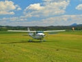 Small sport airplane is rolling or moving on grass airport.Tree edge propeller is quickly turning Royalty Free Stock Photo